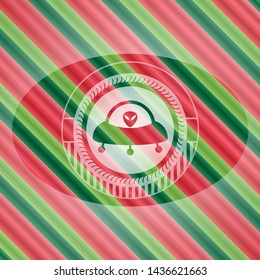 ufo with aline inside icon inside christmas style emblem.