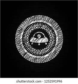 ufo with aline inside icon drawn on a chalkboard