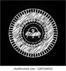ufo with aline inside icon drawn on blackboard