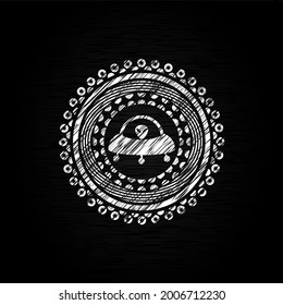 ufo with aline inside icon drawn on a blackboard. 