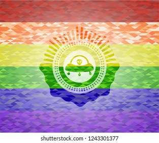 ufo with aline inside icon inside emblem on mosaic background with the colors of the LGBT flag