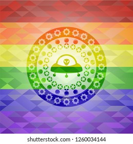 ufo with aline inside icon inside emblem on mosaic background with the colors of the LGBT flag