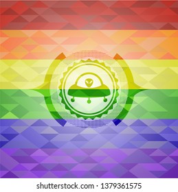 ufo with aline inside icon inside emblem on mosaic background with the colors of the LGBT flag