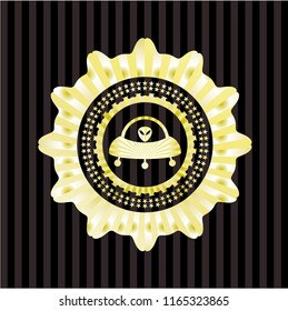 ufo with aline inside icon inside gold shiny badge
