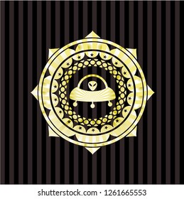 ufo with aline inside icon inside gold badge or emblem