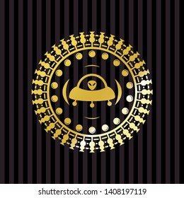 ufo with aline inside icon inside gold shiny emblem