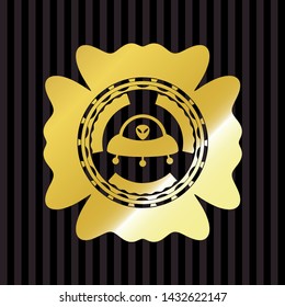 ufo with aline inside icon inside gold shiny emblem