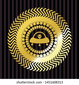 ufo with aline inside icon inside gold badge or emblem