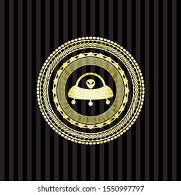 ufo with aline inside icon inside gold badge