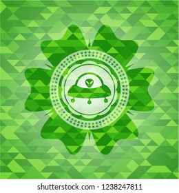 ufo with aline inside icon inside green emblem with mosaic ecological style background