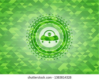 ufo with aline inside icon inside green mosaic emblem