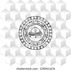 ufo with aline inside icon inside grey icon or emblem with geometric cube white background