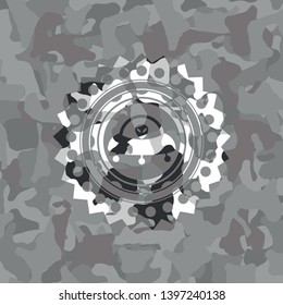ufo with aline inside icon inside grey camouflage emblem