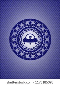 ufo with aline inside icon inside jean or denim emblem or badge background