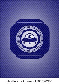 ufo with aline inside icon inside jean or denim emblem or badge background