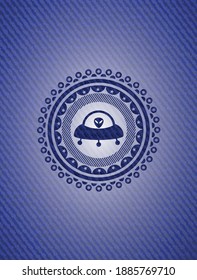 ufo with aline inside icon inside jean or denim emblem or badge background. 