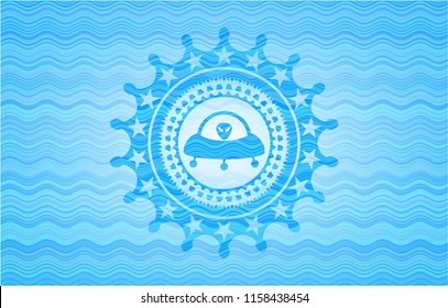 ufo with aline inside icon inside light blue water emblem.