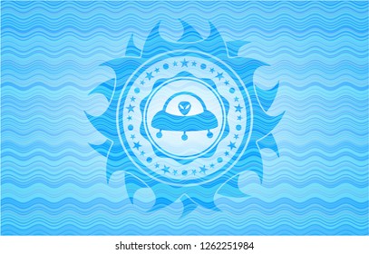 ufo with aline inside icon inside light blue water wave badge.