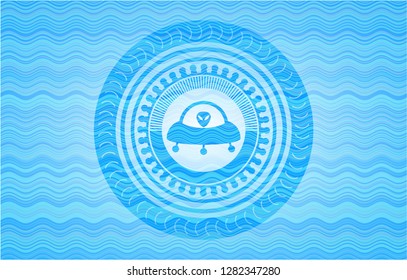 ufo with aline inside icon inside light blue water badge background.
