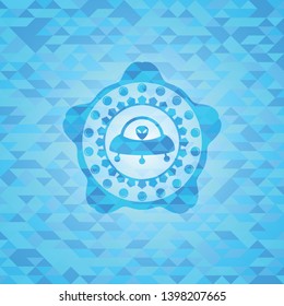 ufo with aline inside icon inside light blue emblem with triangle mosaic background