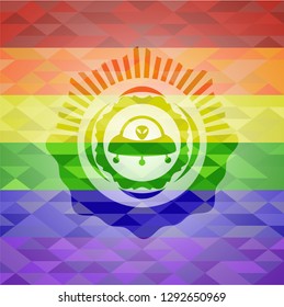 ufo with aline inside icon on mosaic background with the colors of the LGBT flag