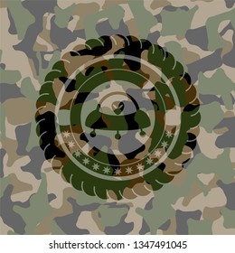 ufo with aline inside icon on camouflaged texture