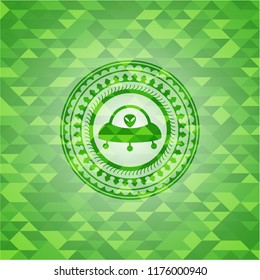 ufo with aline inside icon inside realistic green emblem. Mosaic background