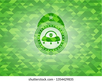 ufo with aline inside icon inside realistic green emblem. Mosaic background