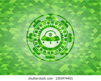 ufo with aline inside icon inside realistic green emblem. Mosaic background
