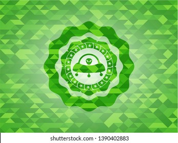 ufo with aline inside icon inside realistic green mosaic emblem