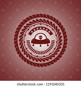 ufo with aline inside icon inside red emblem