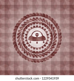 ufo with aline inside icon inside red seamless emblem or badge with geometric pattern background.