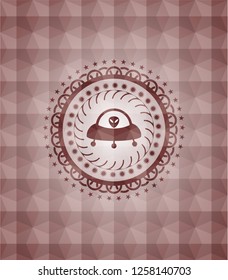 ufo with aline inside icon inside red seamless emblem or badge with abstract geometric polygonal pattern background.