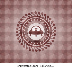 ufo with aline inside icon inside red seamless emblem with geometric background.