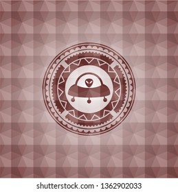 ufo with aline inside icon inside red seamless badge with geometric pattern background.