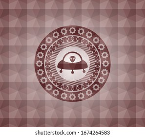 ufo with aline inside icon inside red seamless emblem with geometric pattern background.