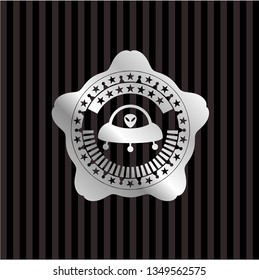 ufo with aline inside icon inside silver emblem
