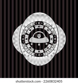 ufo with aline inside icon inside silvery emblem. 