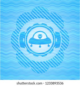 ufo with aline inside icon inside sky blue water wave badge.