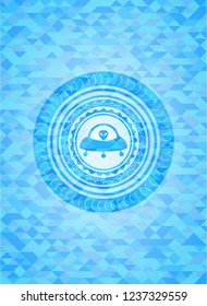 ufo with aline inside icon inside sky blue emblem with mosaic background