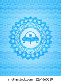 ufo with aline inside icon inside sky blue water wave emblem background.