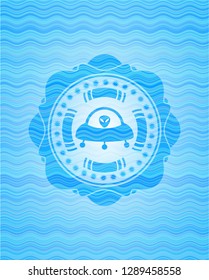ufo with aline inside icon inside sky blue water wave emblem background.
