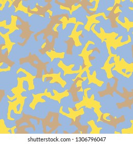 UFO camouflage of various shades of yellow, brown and blue colors. It is a colorful seamless pattern that can be used as a camo print for clothing and background and backdrop or computer wallpaper