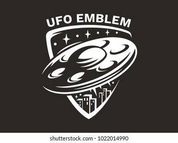 UFO flies in the sky above the multi-storey buildings of the city and emits light - emblem, vector illustration, print, sticker set on a black background.