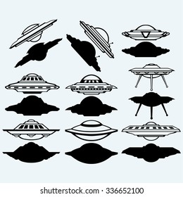 UFO flying saucer set icon. Isolated on blue background. Vector silhouettes