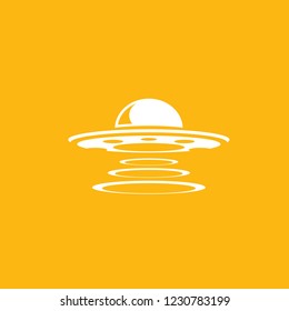 Ufo flying saucer vector icon isolated on orange background. Ufo logo design template