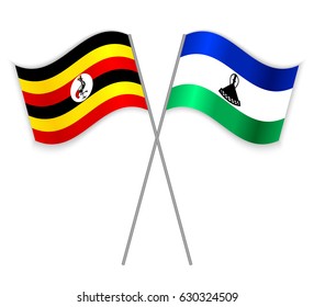 Ugandan and Basotho crossed flags. Uganda combined with Lesotho isolated on white. Language learning, international business or travel concept.