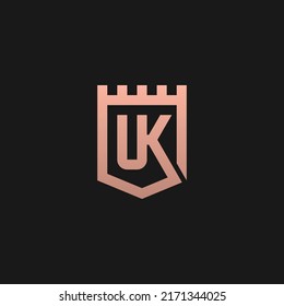 UK monogram logo inside fort shield frame - gold color