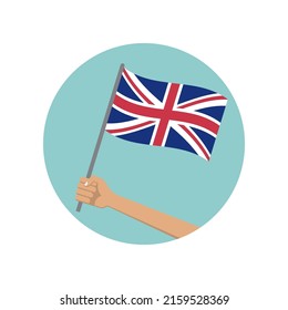 UK waving flag circle icon. Hand holding British flag. National symbol of Great Britain. Vector illustration.