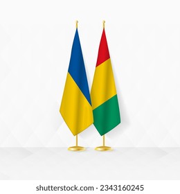 Ukraine and Guinea flags on flag stand, illustration for diplomacy and other meeting between Ukraine and Guinea. Vector illustration.
